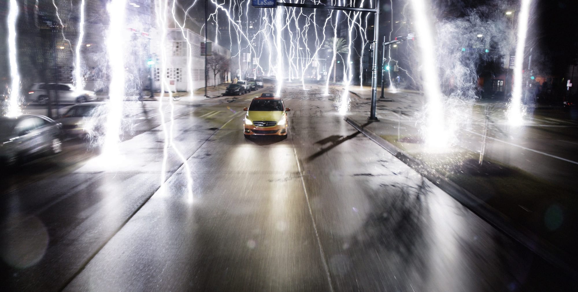 From Geostorm, a little yellow car speeds away from dozens of simultaneous lightning strikes.