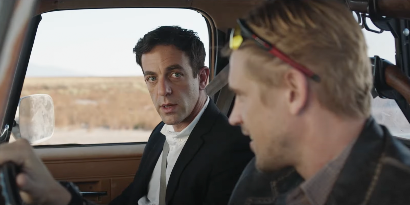 BJ Novak looking incredulously at the car's driver from the passenger seat. From Vengeance.