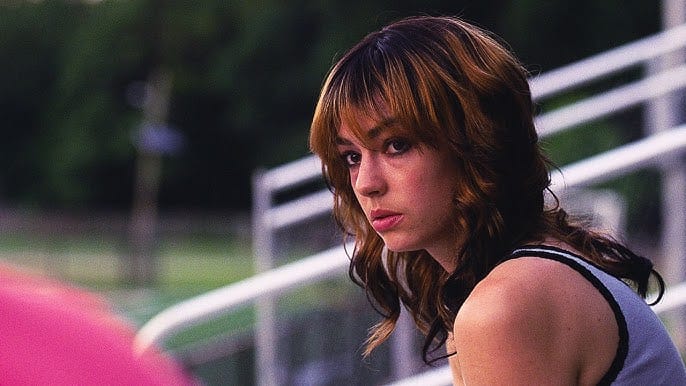 Brigette Lundy Paine sitting on the school bleachers in I Saw The TV Glow.