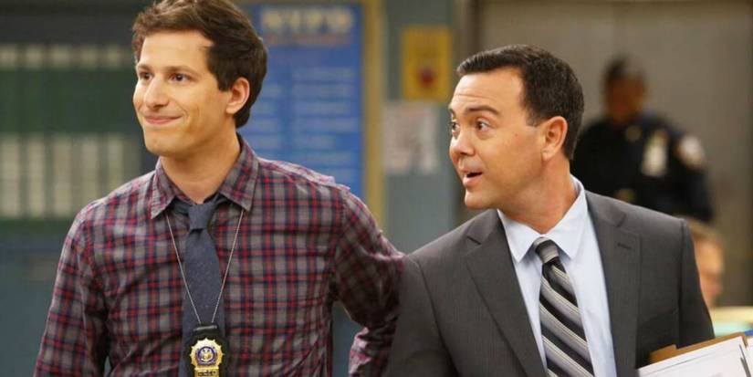 Brooklyn 9-9: Jake Peralta and Charles Boyle in the precinct, looking at something left of the frame.