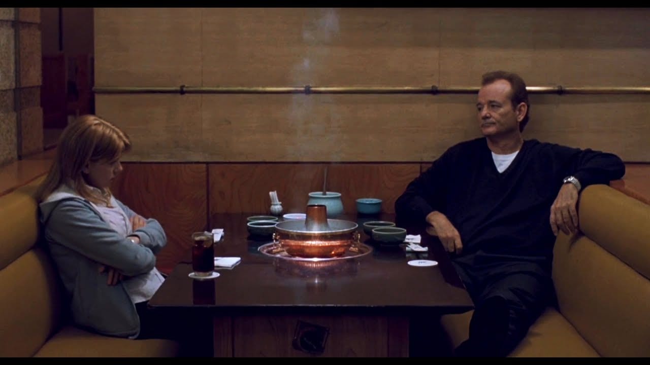 Lost in Translation: Bob and Charlotte sit on opposite sides of a Shabu Shabu booth, glaring at each other.