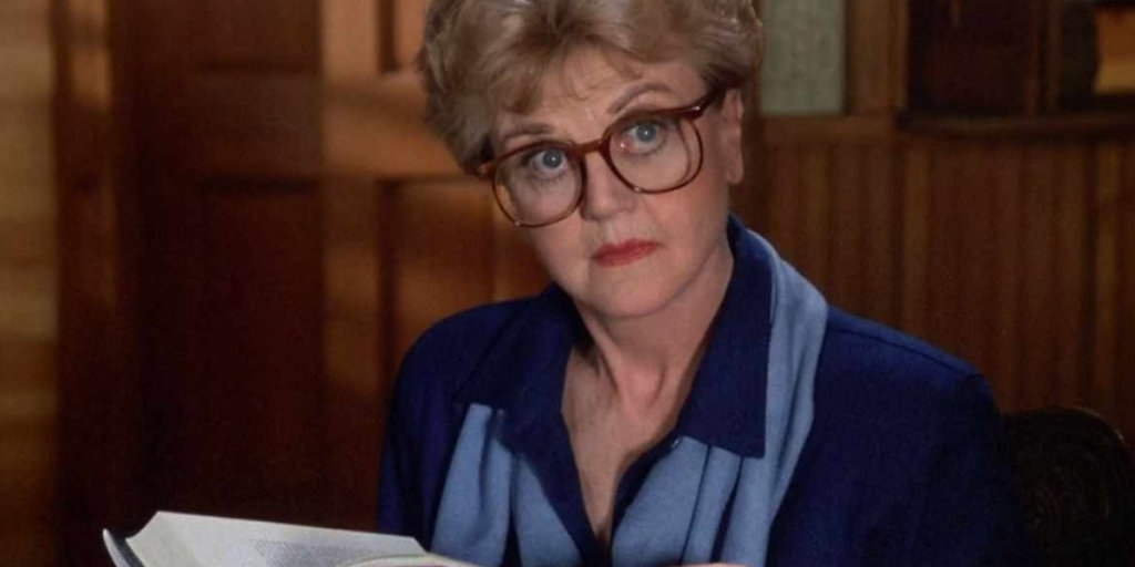 Murder, She Wrote: Jessica Fletcher wearing glasses while looking up from a book.
