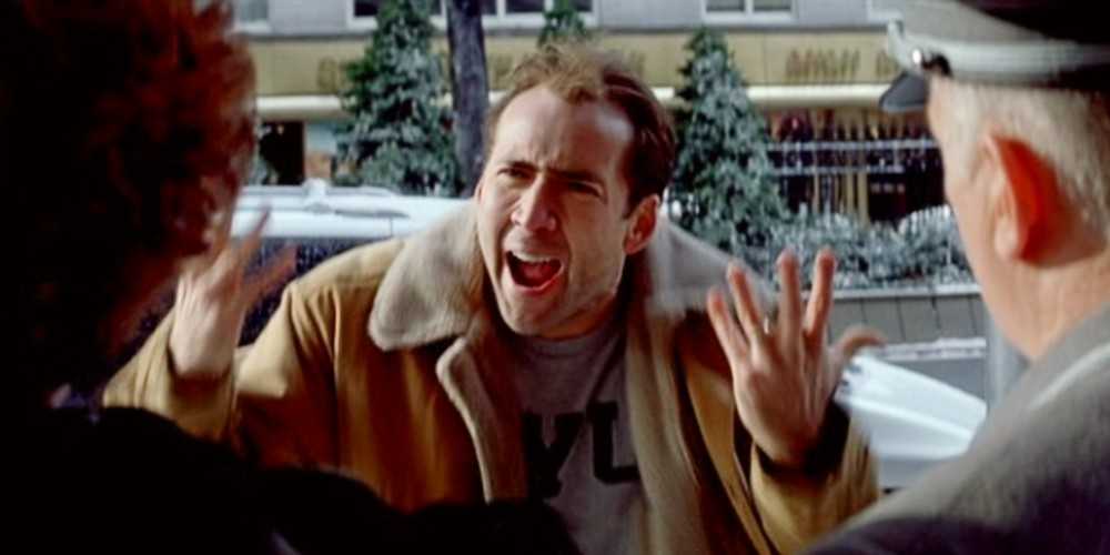 The Family Man - Nicolas Cage yells with his hands as he tries to explain that he doesn't understand what's happening.