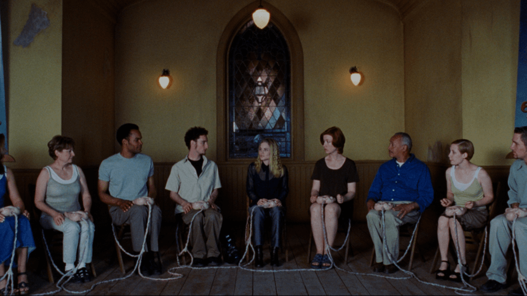 Existenz - A focus group prepares to beta test a video game with organic controllers in their laps connected to the control ports in their bodies.