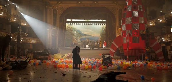 From the movie Phantom Thread: a couple dances in an empty ballroom after a new year's party