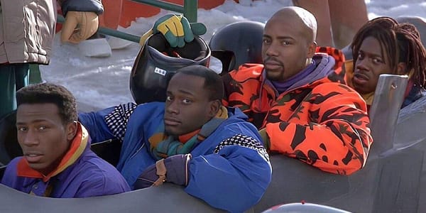 Four Jamaican bobsledders in a scene from Cool Runnings