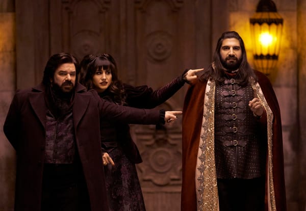 Two vampires point at another vampire in a scene from What We Do in the Shadows